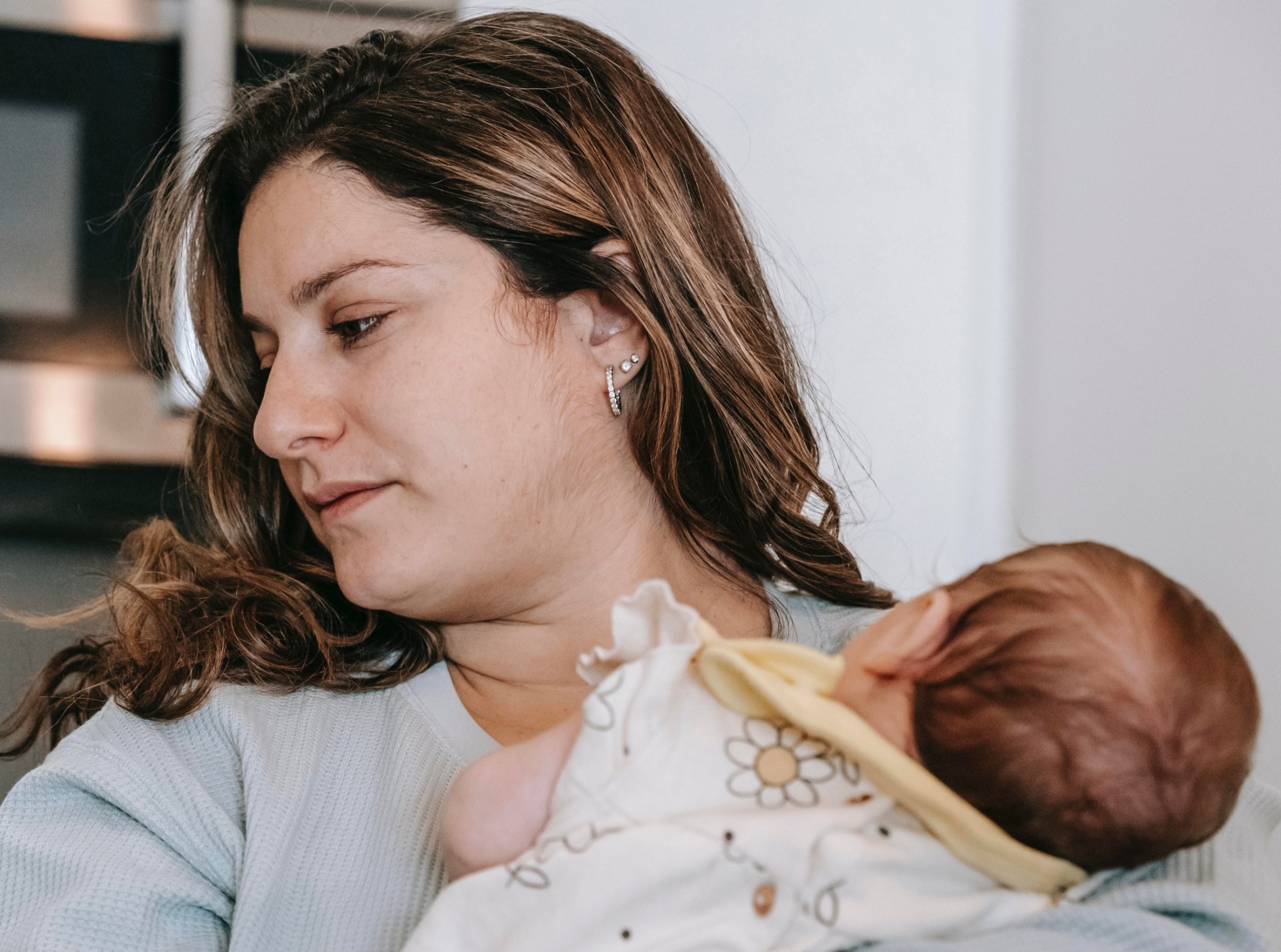 Sad mom holding baby